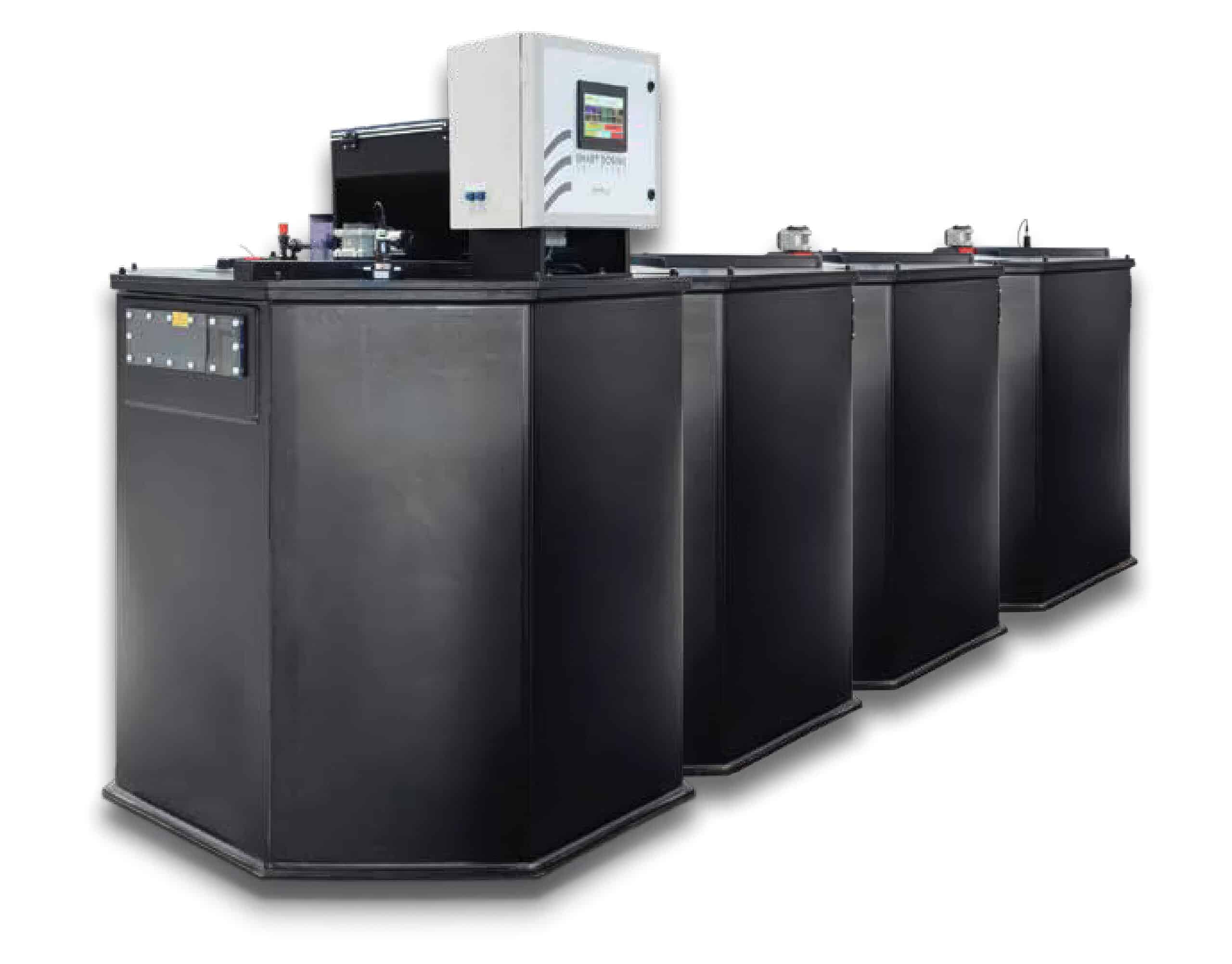 Four large, black industrial machines are aligned in a row, with a control panel and digital display mounted on the front unit. The machines have a modern, angular design and are shown against a plain white background.